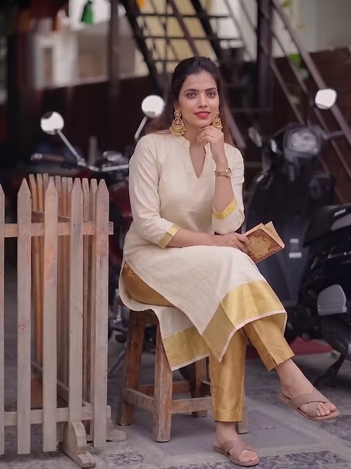 Golden kasavu tissue kurti sitting view